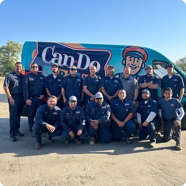 can do crew plumbing heating and ac technicians posing in two rows in front of service vehicle