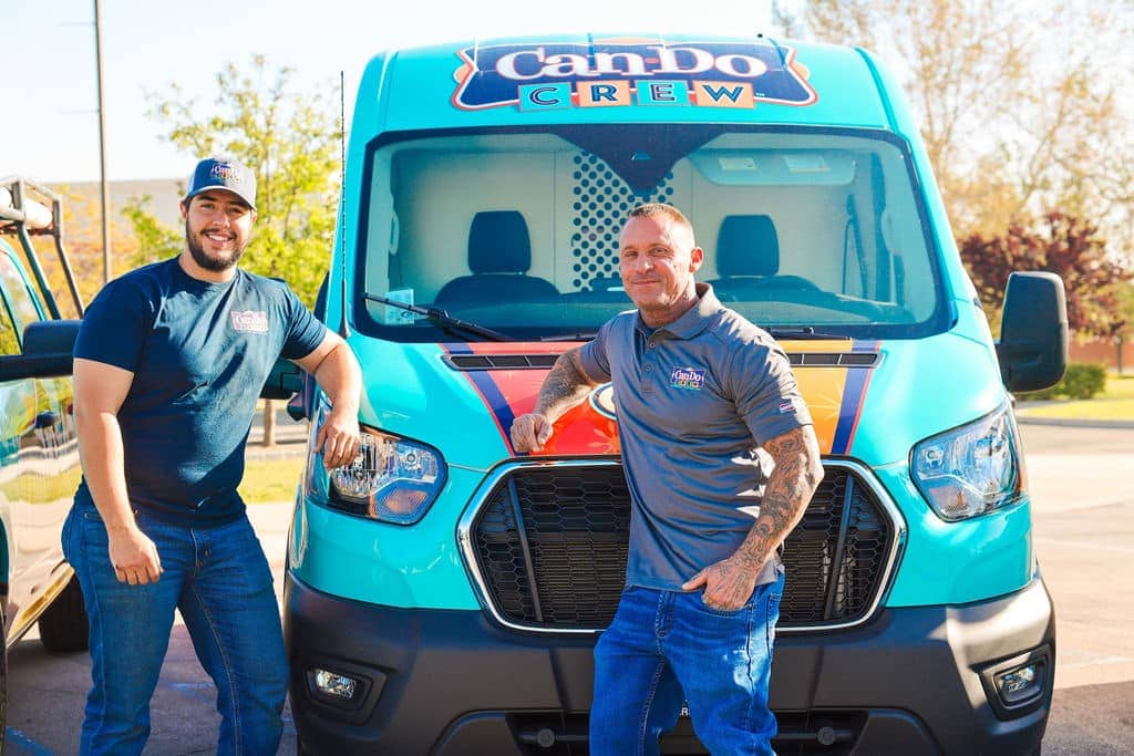 two men in front of van