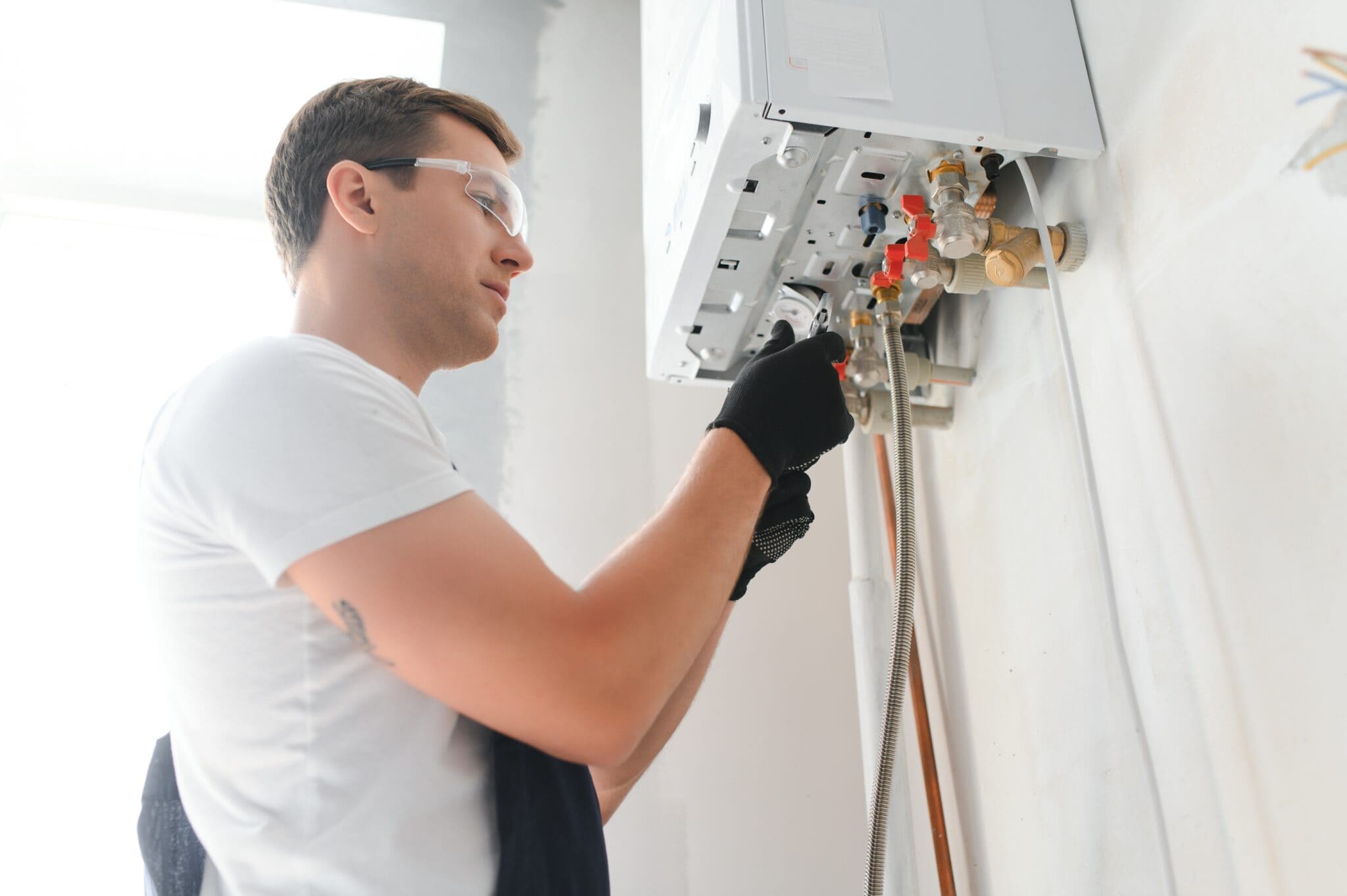 technician repairing water heater