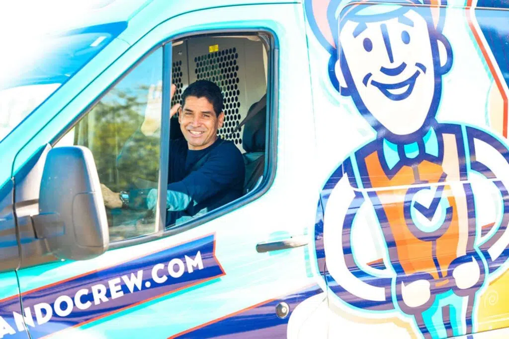 man waving in work van