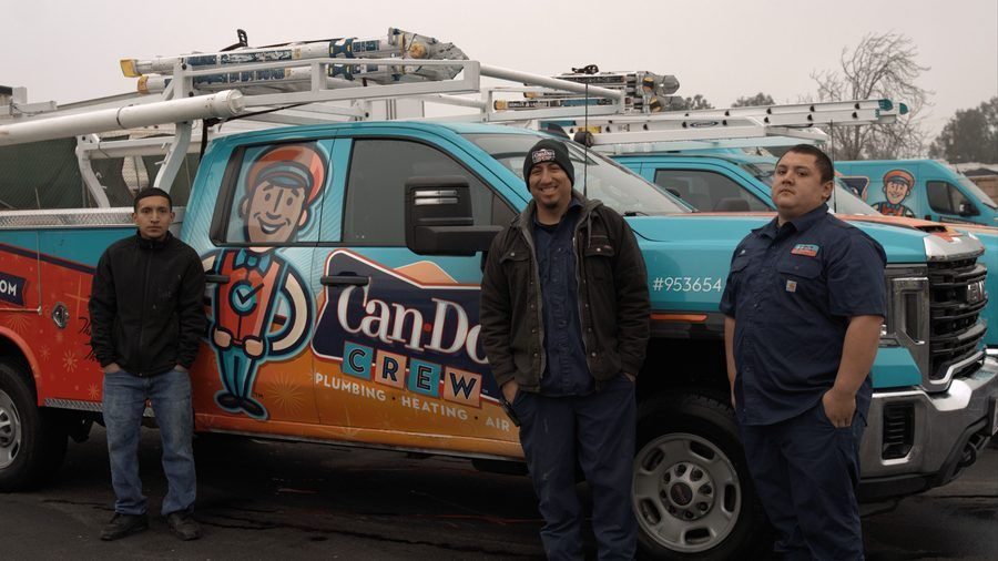 Can Do Crew plumbing standing in front of truck.