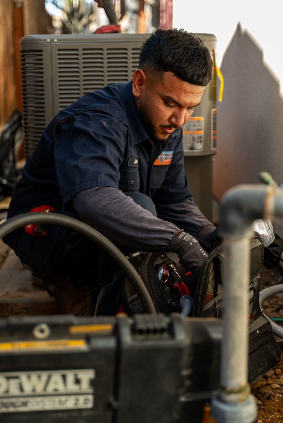 HVAC tech repairing heat pump.