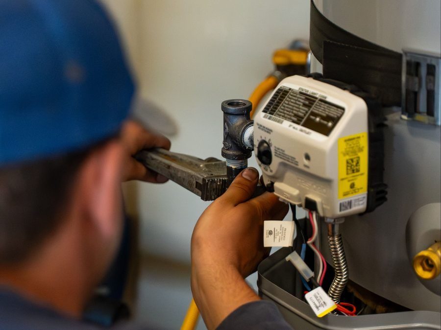 Plumber repairing water heater.